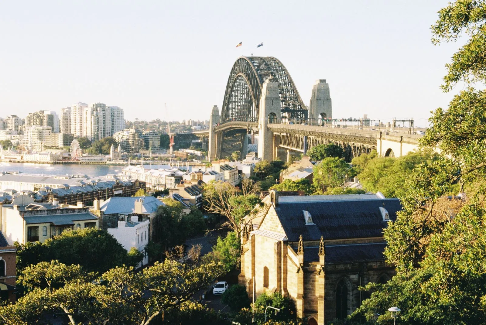 Panoramic view of Sydney Harbour Bridge with city skyline in the background.